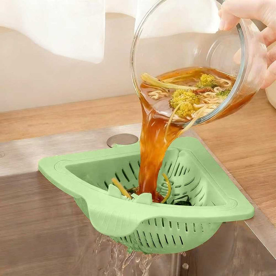 Sink strainer basket catching food scraps and vegetable peels